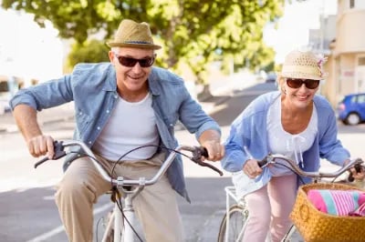 Happy mature couple going for a bike ride in the city on a sunny day-1 (1)