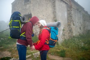 senior couple on a hiking date on rainy day 